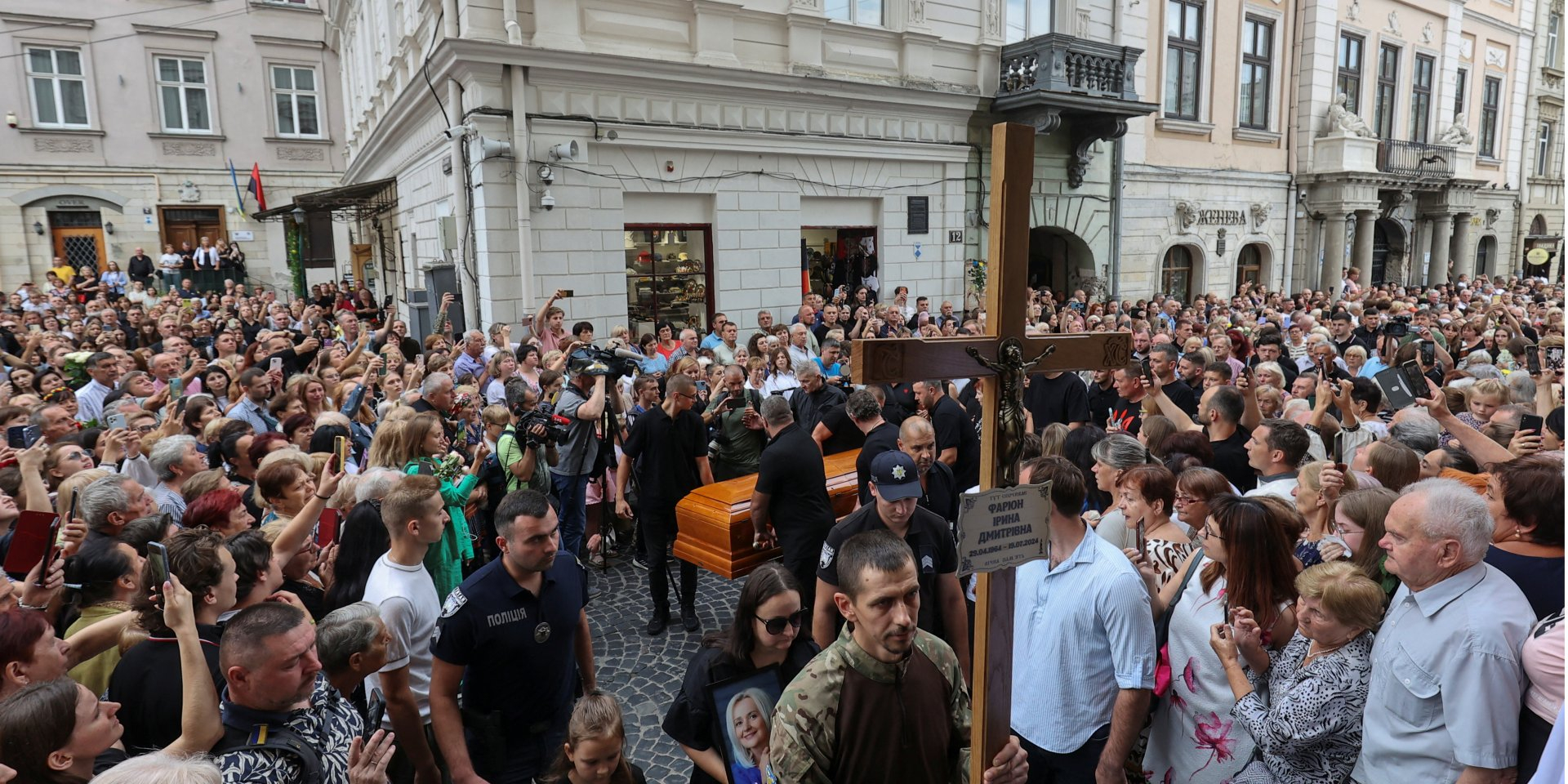 People walk during the funeral procession for Ukrainian professor and politician Iryna Farion on July 21, 2024. (Photo: REUTERS/Roman Baluk)